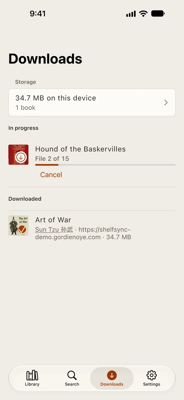 The Downloads tab with a finished book and one still downloading